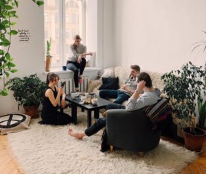 people gathered inside house sitting on sofa