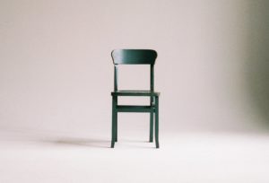 green wooden chair on white surface